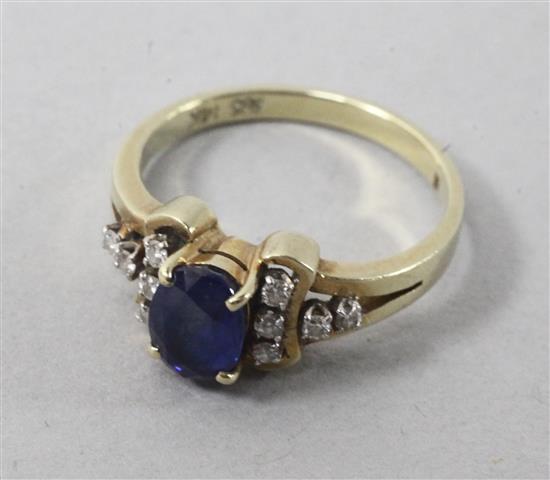 A 14ct gold sapphire and diamond cluster ring, size M.